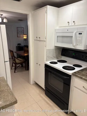 a kitchen with a stove and a refrigerator