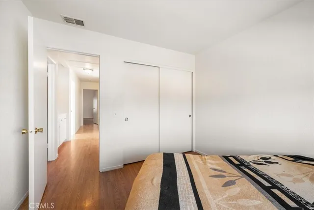 a view of a bedroom with wooden floor and bedroom