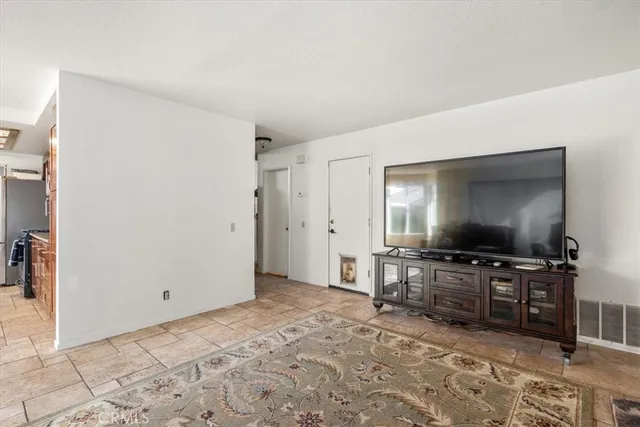a view of a livingroom with wooden floor and a flat screen tv