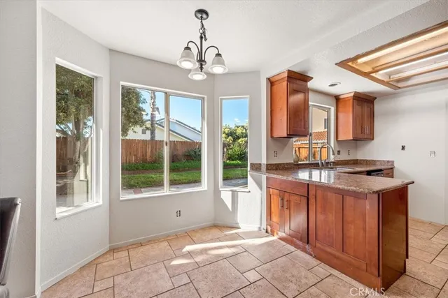 a open kitchen with a sink stove and refrigerator