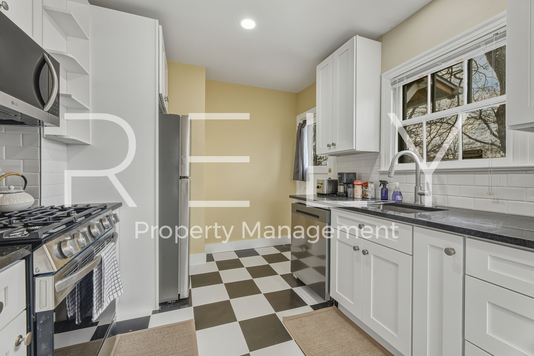 933 East 56th 1/2 Street Austin, TX 78751 - Photo 22 of 37 a kitchen with stainless steel appliances granite countertop a stove a sink and a refrigerator