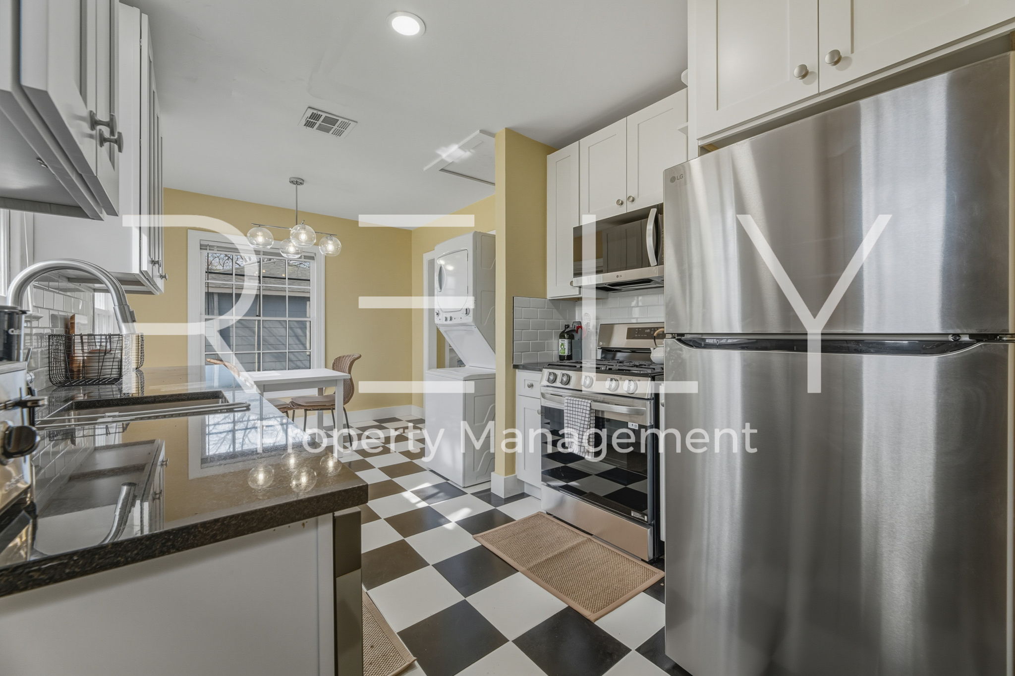 933 East 56th 1/2 Street Austin, TX 78751 - Photo 23 of 37 a kitchen with stainless steel appliances a sink and a refrigerator