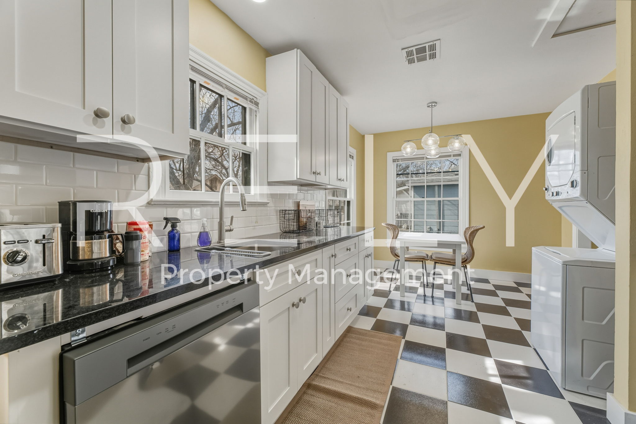 933 East 56th 1/2 Street Austin, TX 78751 - Photo 24 of 37 a kitchen with stainless steel appliances a sink a stove a refrigerator and cabinets