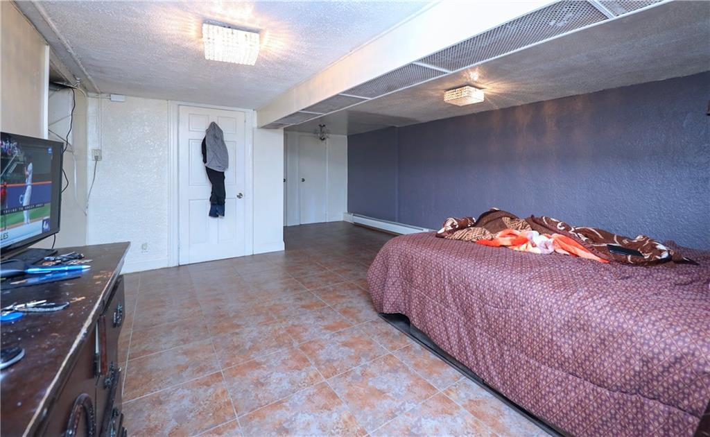 5723 Ave. M Brooklyn, NY 11234 - Photo 14 of 28 a bed room with a bed and a television