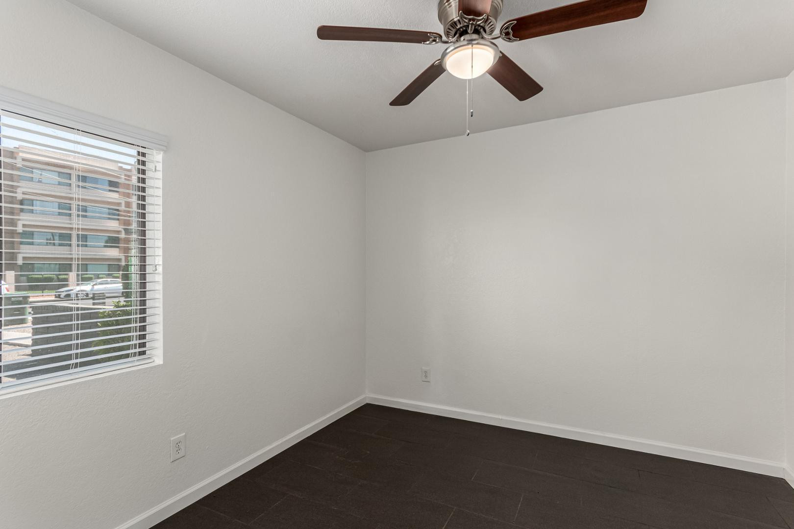 3034 North 35th Street, Unit 3 Phoenix, AZ 85018 - Photo 6 of 10 an empty room with a window and a fan