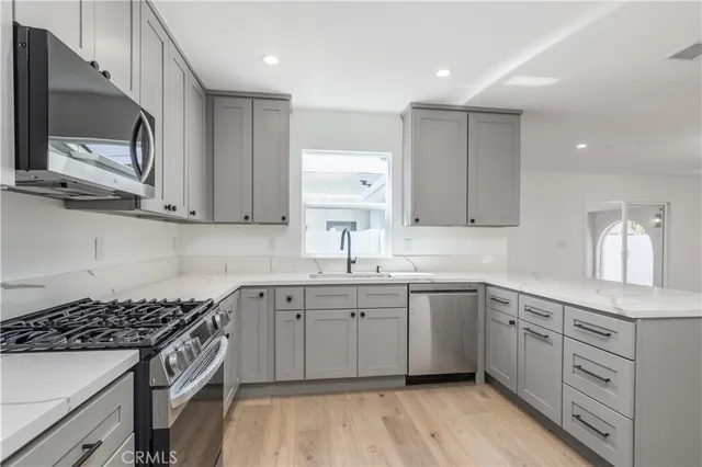 a kitchen with a sink stove and microwave