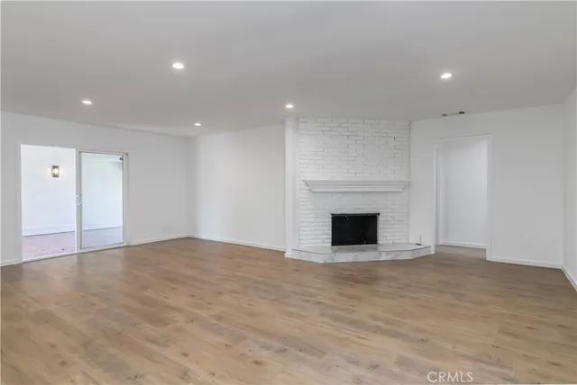 a kitchen with granite countertop white cabinets and stainless steel appliances