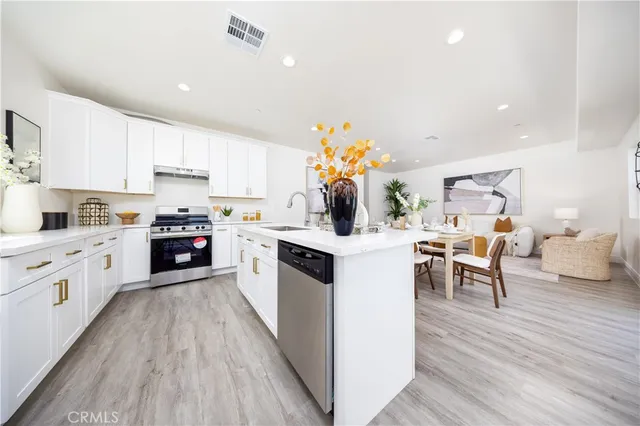 a kitchen with white cabinets and counter space