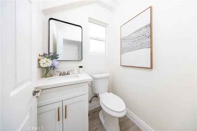 a bathroom with a sink mirror and a toilet