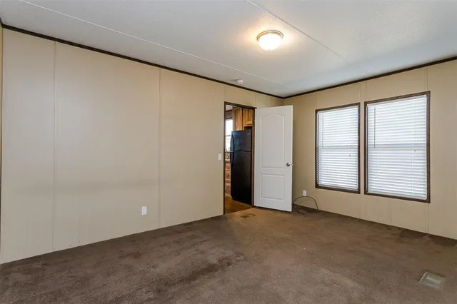 an empty room with a empty space and windows