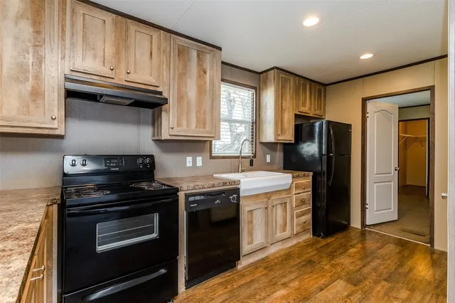 a kitchen with stainless steel appliances granite countertop a stove a refrigerator and a sink