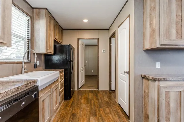 a kitchen with a refrigerator and a sink