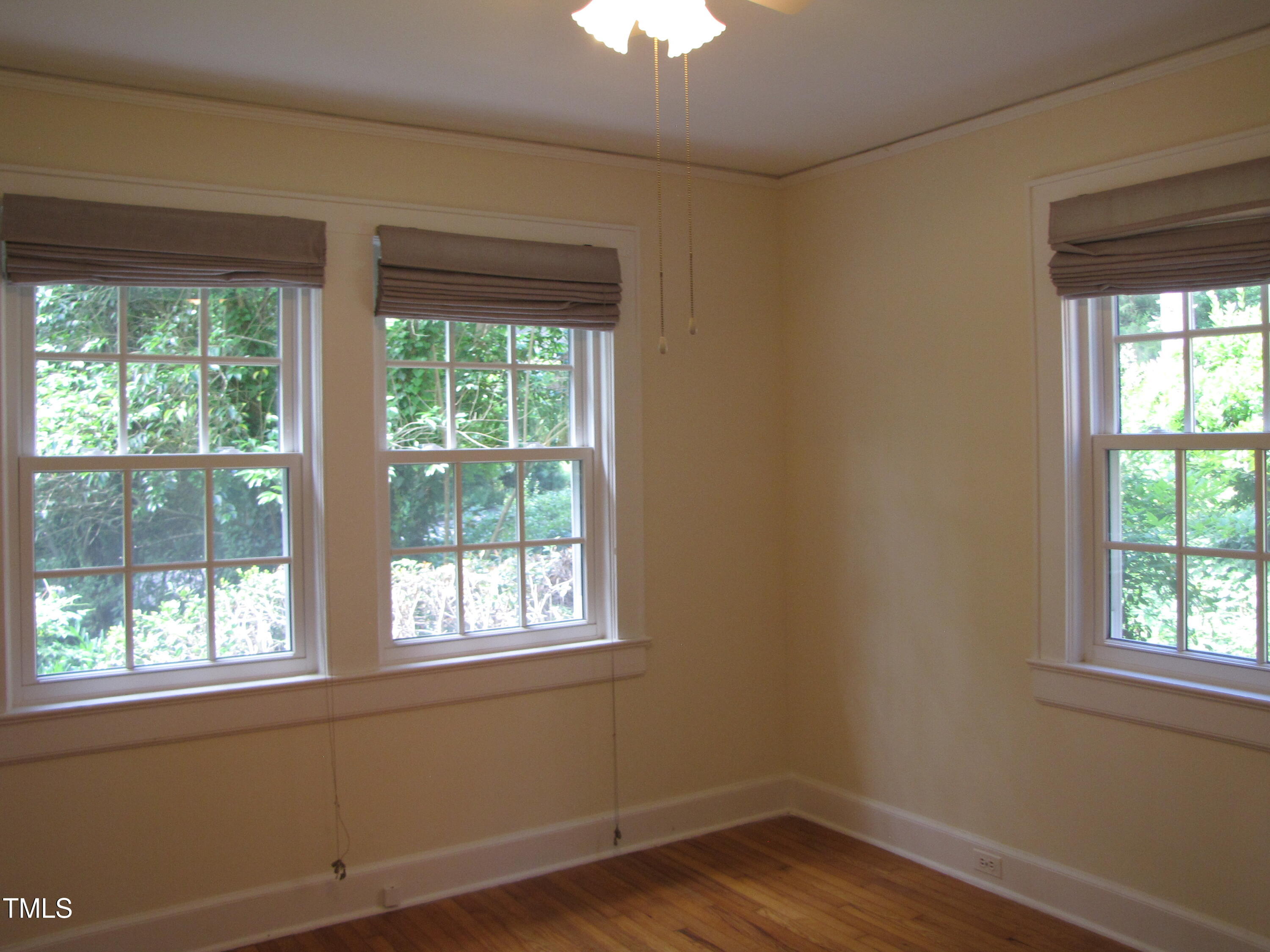 1024 Starlight Drive Durham, NC 27707 - Photo 11 of 18 a view of an empty room with wooden floor and a window