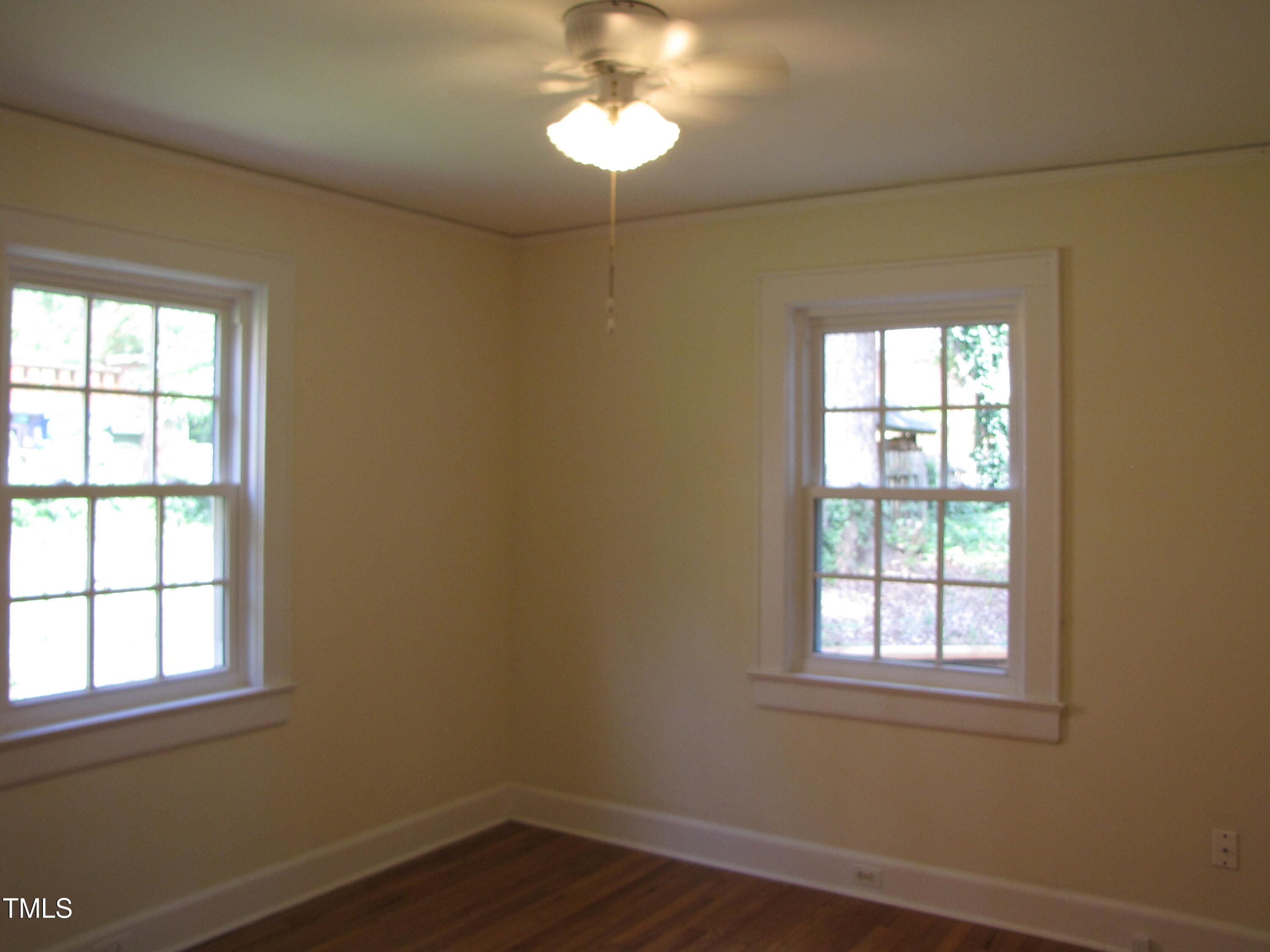 1024 Starlight Drive Durham, NC 27707 - Photo 14 of 18 a view of an empty room with wooden floor and a window