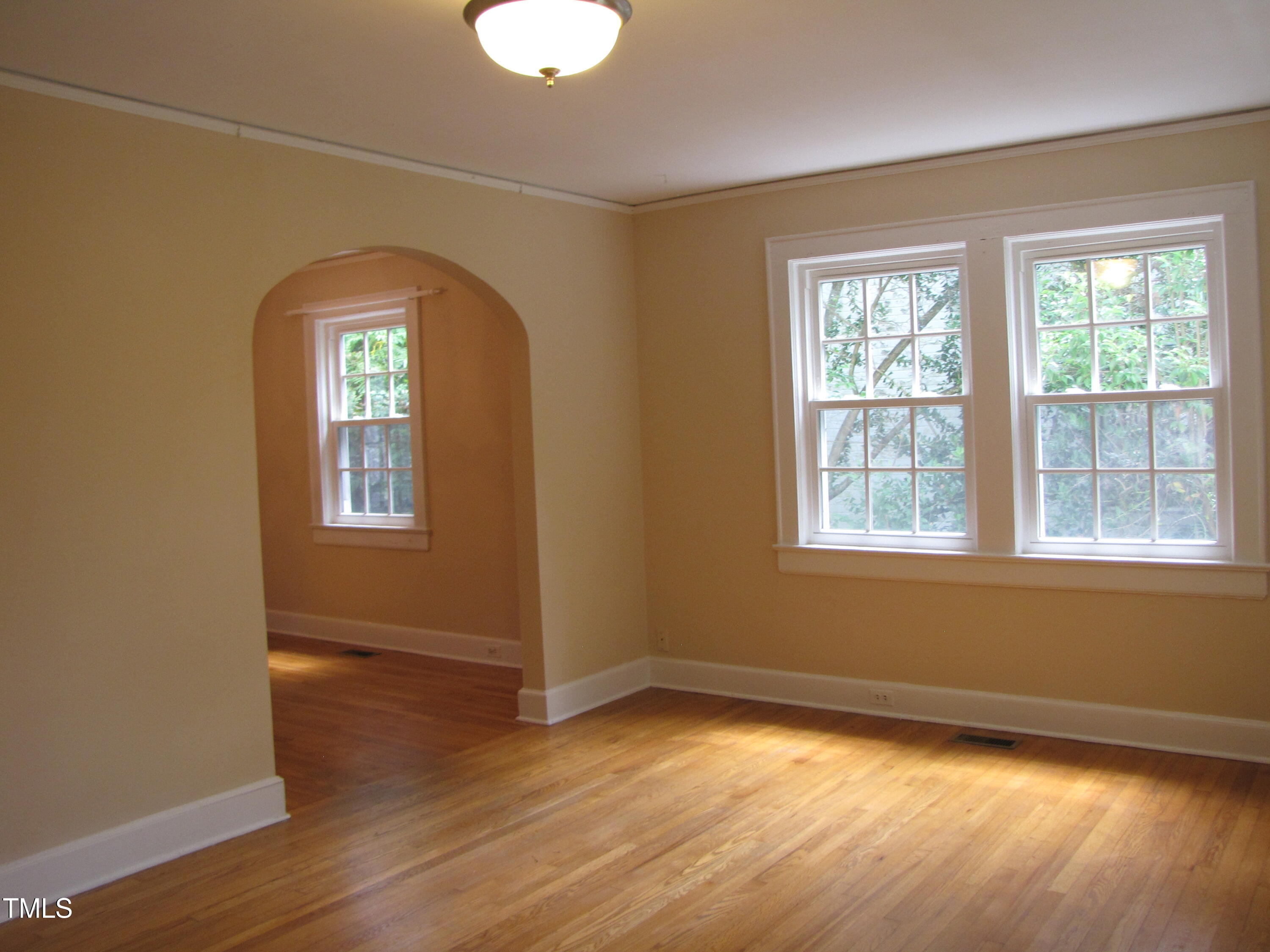 1024 Starlight Drive Durham, NC 27707 - Photo 3 of 18 a view of empty room with wooden floor and fan