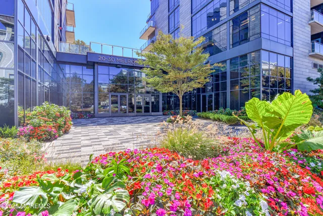 a vase of flowers sitting in front of brick building