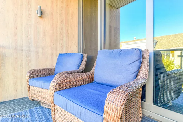 a view of a bedroom with furniture and wooden floor