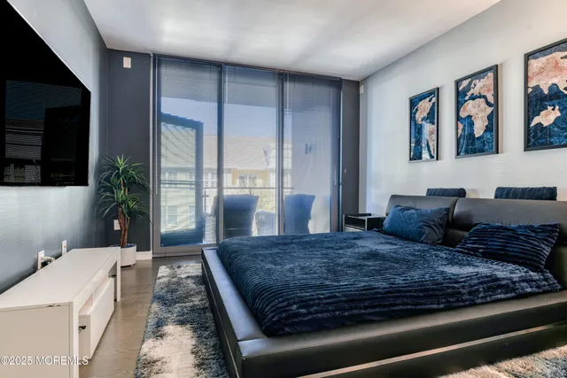 a large bedroom with a large bed a rug and windows