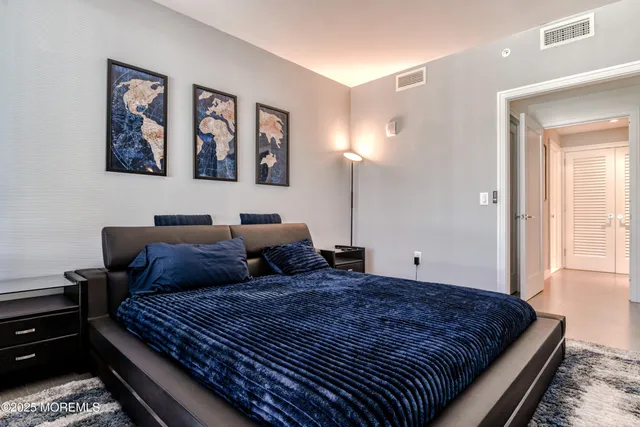 a bedroom with bed and wall painting