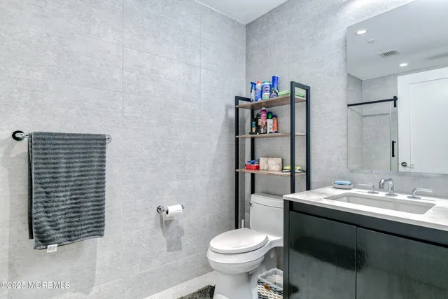 a bathroom with a sink toilet and a shower