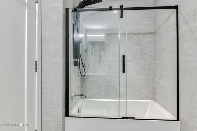 a bathroom with a glass shower door