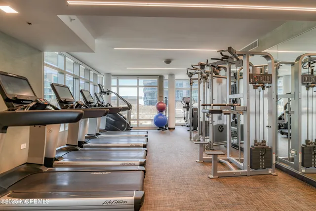 a living room with lots of furniture and gym equipment