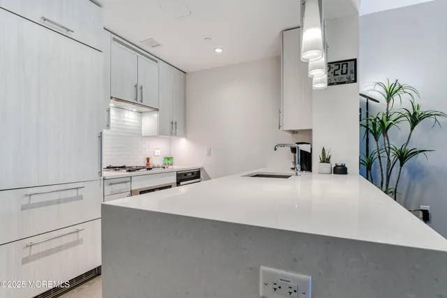 a kitchen with stainless steel appliances a refrigerator sink and stove