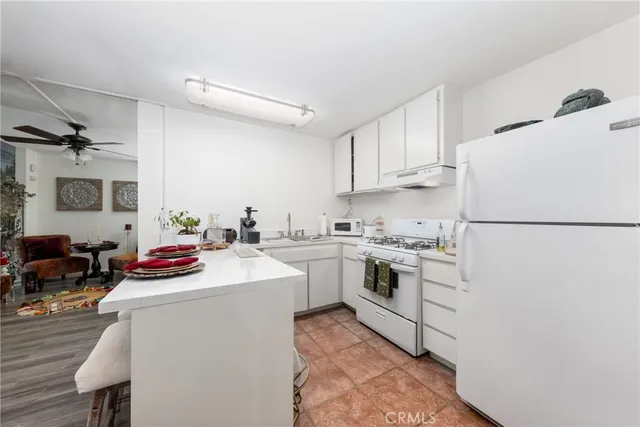 a kitchen with a sink stove and white cabinets