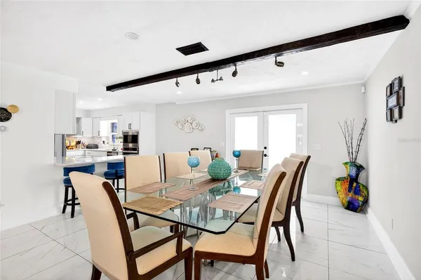 a view of a dining room with furniture and a potted plant