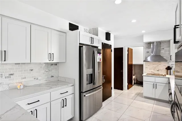 a kitchen with stainless steel appliances granite countertop a refrigerator and a sink