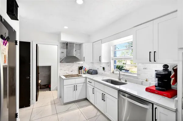 a kitchen with a sink stainless steel appliances and cabinets