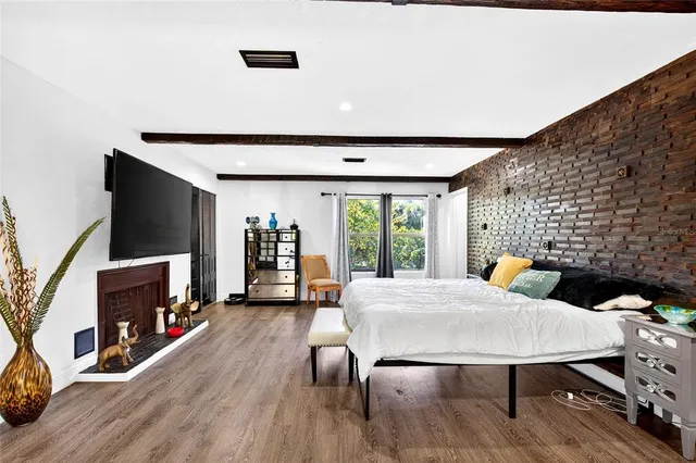 a living room with a bed furniture and a flat screen tv