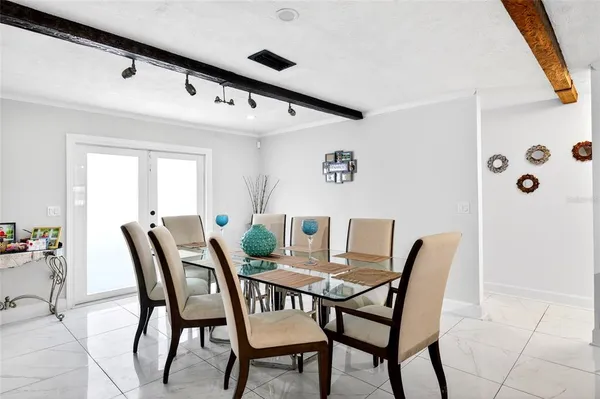 a view of a patio with table and chairs with wooden floor and fence