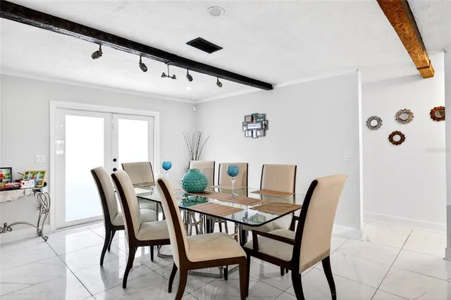 a view of a patio with table and chairs with wooden floor and fence