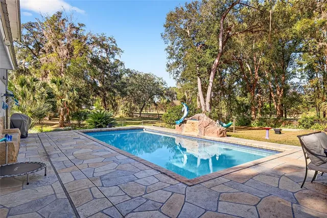 a view of a swimming pool with an outdoor seating