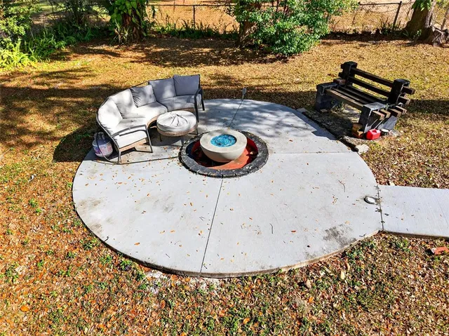 a view of a patio with table and chairs couches under an umbrella
