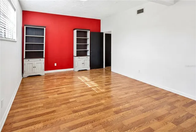 a view of an empty room with closet