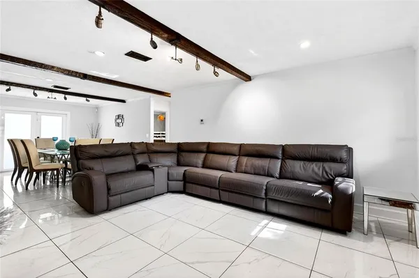 a living room with furniture and a dining table
