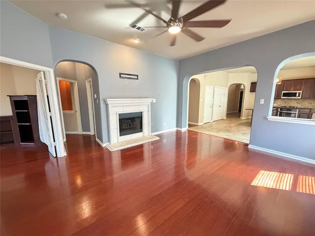 a view of livingroom with kitchen and wooden floor