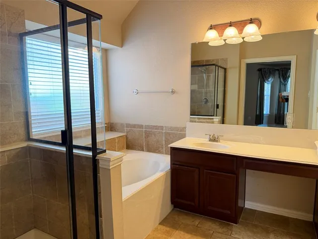 a bathroom with a double vanity sink and a bathtub