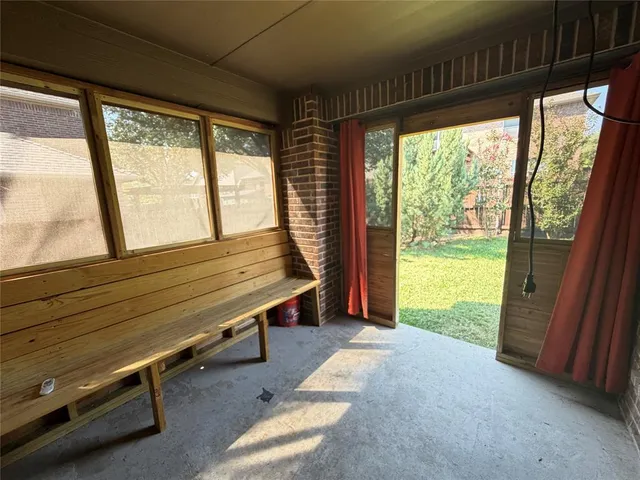 a view of a room with wooden floor and furniture