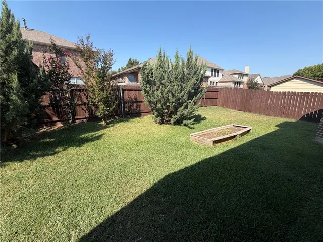 a view of a backyard with sitting area