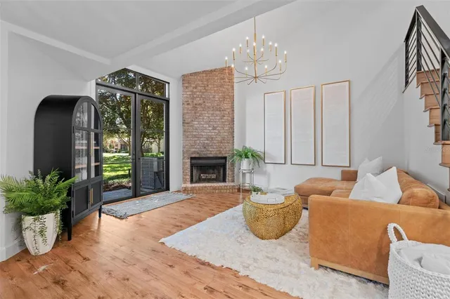 a living room with furniture potted plant and a fireplace