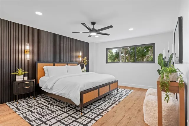 a bedroom with a bed and a potted plant