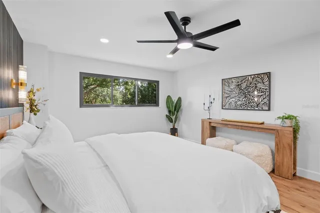a bedroom with a large bed and a large window