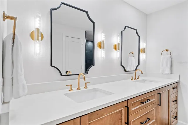 a bathroom with a double vanity sink and a mirror