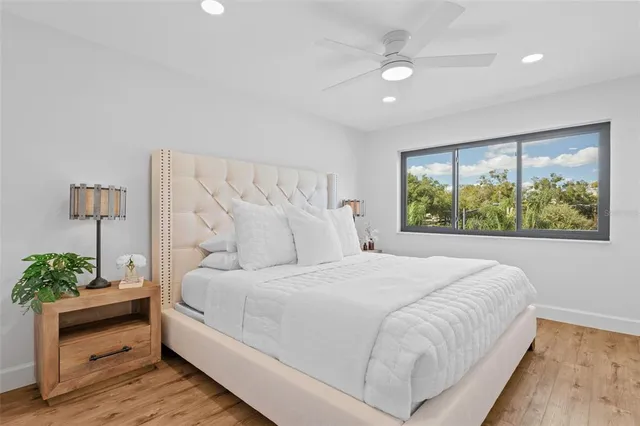 a bedroom with a large bed and a window