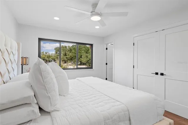 a bedroom with a large bed and a large window