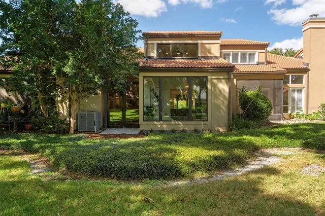 front view of a brick house with a yard