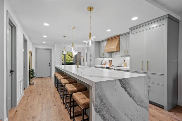 a kitchen with counter top space sink and refrigerator
